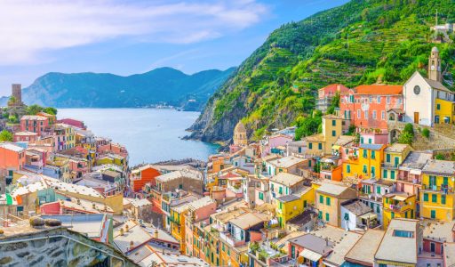 Vernazza village with typical colorful multicolored buildings houses, Castello Doria castle on rock, green hills and Genoa Gulf, Ligurian Sea, National park Cinque Terre, La Spezia, Liguria, Italy